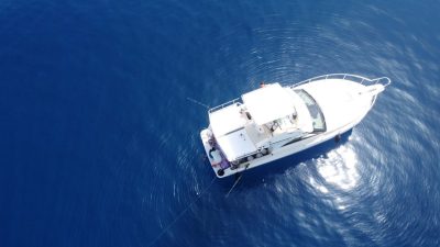 An aerial view of a boat on the open sea.